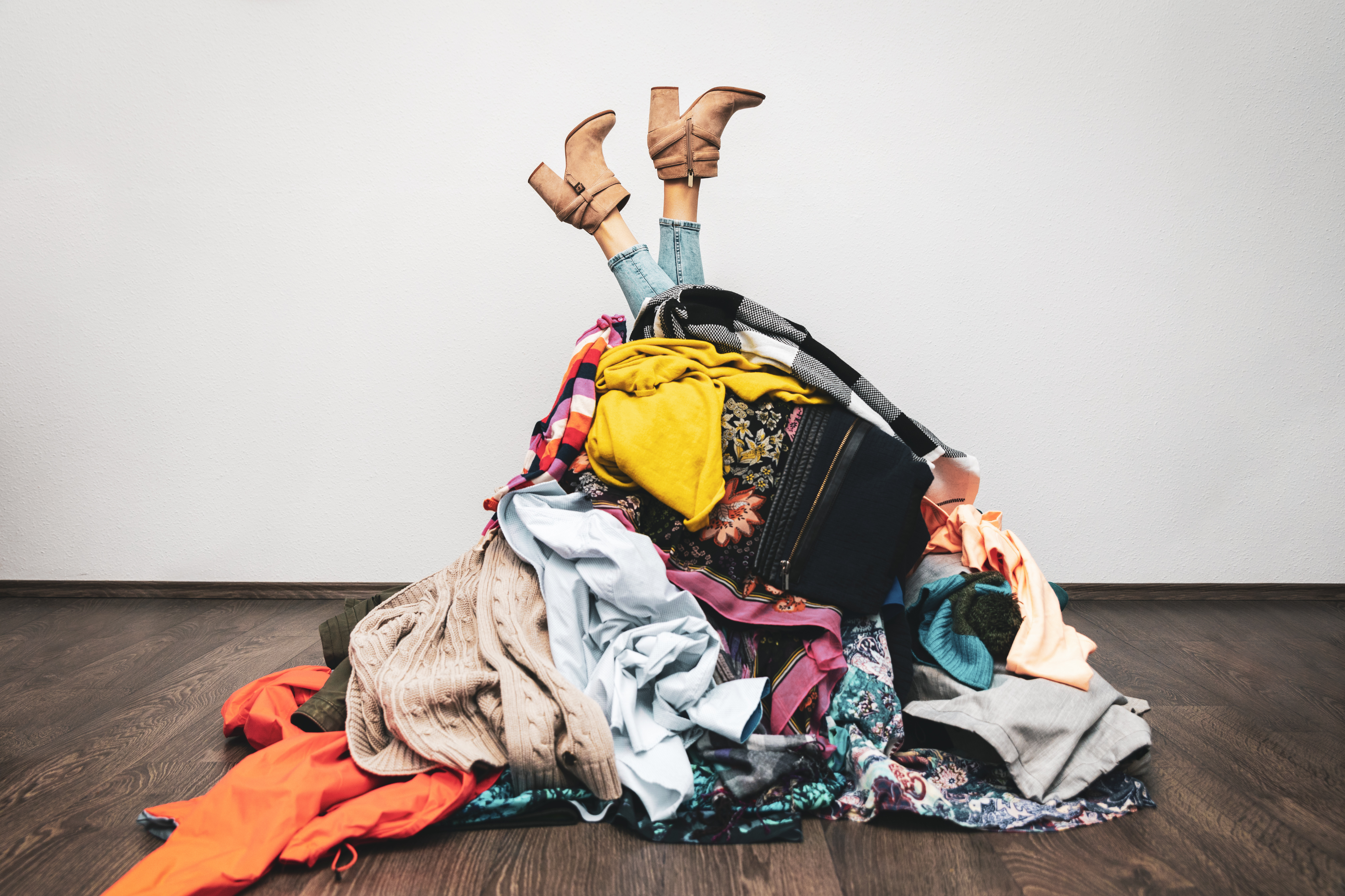 A person underneath a pile of clothes.