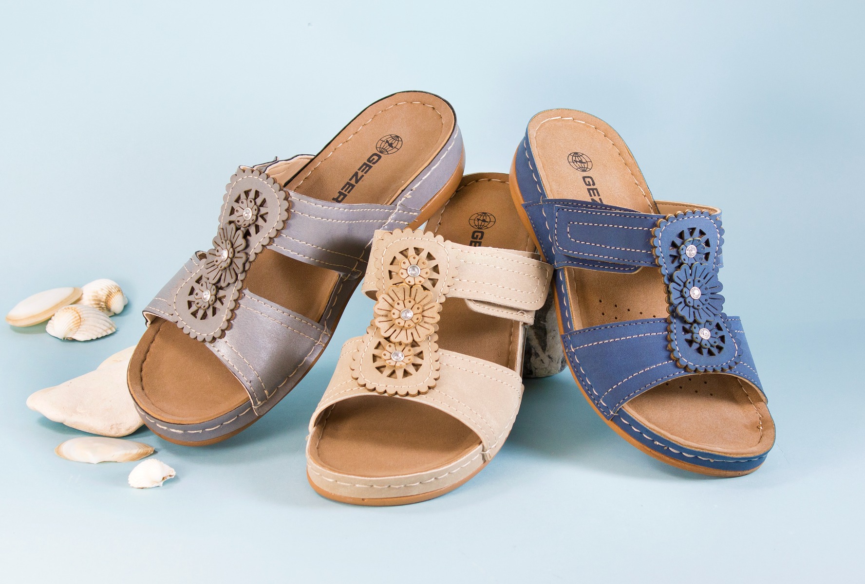Three pairs of slip on sandals.
